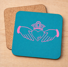 Load image into Gallery viewer, Claddagh Blue pot stand – pink Claddagh on teal with cork backing