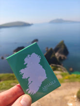 Load image into Gallery viewer, Abhaile – Home Irish map fridge magnet held up over the Kerry coastline
