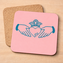 Load image into Gallery viewer, Claddagh Pink pot stand – teal Claddagh on pink with cork backing

