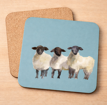 Load image into Gallery viewer, Three Sheep pot stand – three Irish sheep on blue with cork backing
